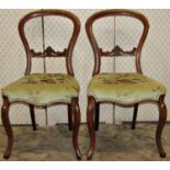 Six Victorian walnut balloonback dining chairs (slight variant in design), with moulded frames