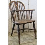 A 19th century Windsor low hoop and stick back elbow chair, principally in yew wood, with central