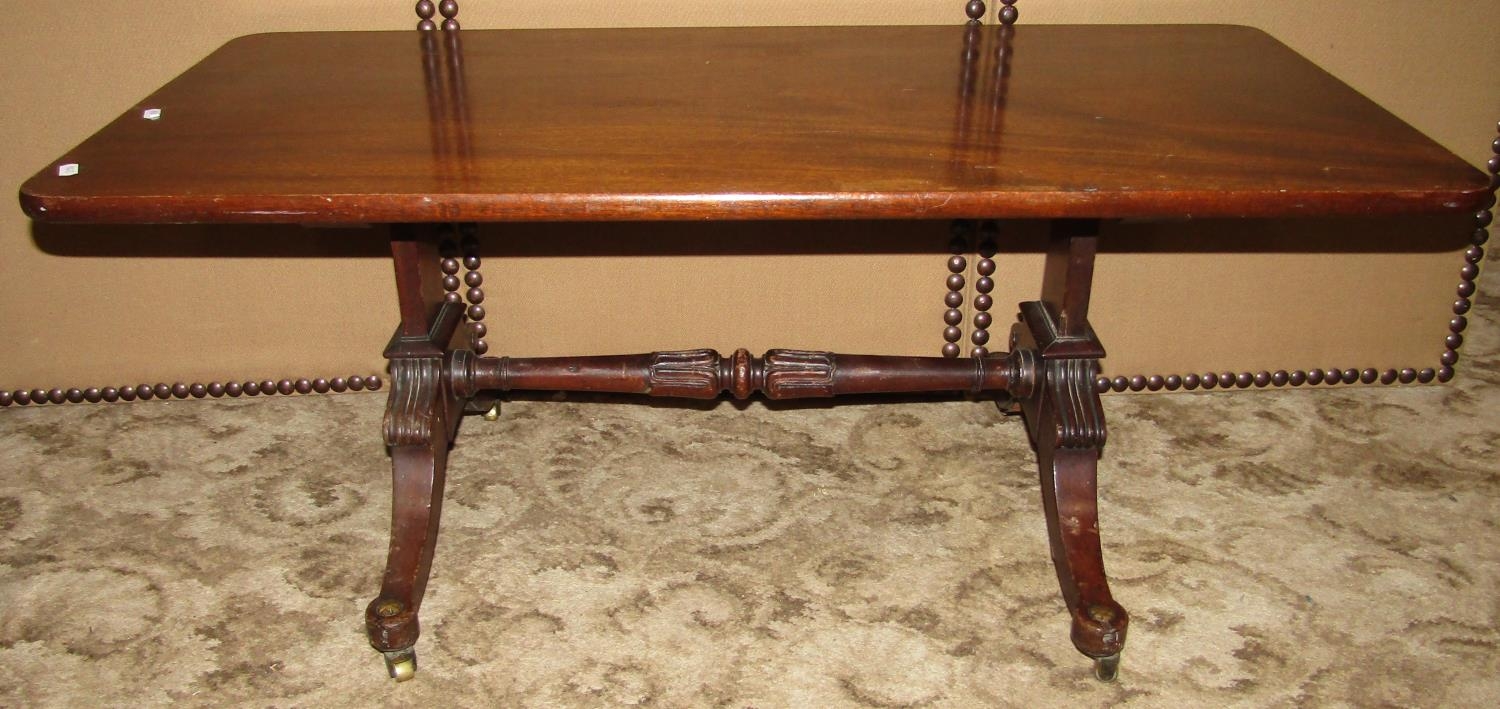 A low mahogany occasional table on Regency swept supports