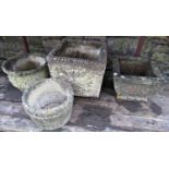 Four weathered cast composition stone garden planters of various size and design with relief detail