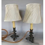 A pair of converted bronze 19th century candle sticks to electric lamps with shades. 40cm high inc