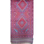 A Meshwanni runner with a diamond pattern in predominately red and blue colourway, 243cm x 60cm