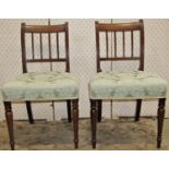 A set of six Regency mahogany dining chairs with reeded stick backs over upholstered seats raised on