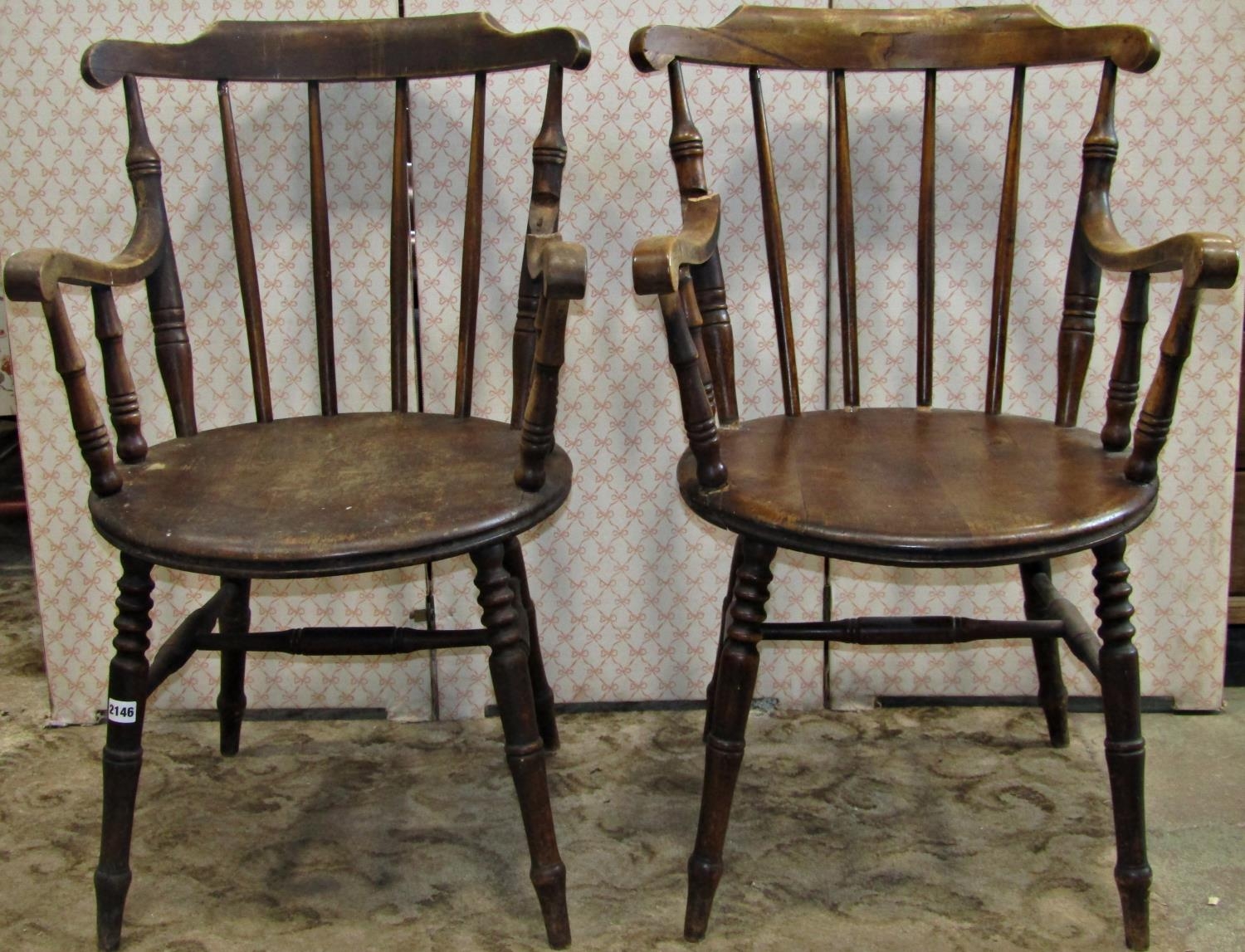 A pair of Swedish stained beechwood stickback armchairs with circular moulded solid seats raised