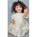 An early 20th century bisque head baby doll designed by Kämmer & Reinhardt (with Simon & Halbig
