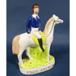 A Staffordshire equestrian figure of Fred Archer with moulded title to front, 23cm tall approx