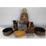 A pair of wine coasters with faux book spine sides, a praying Buddhist monk, a pair of oriental