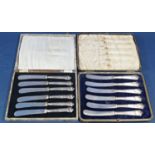 Two cased sets of silver dessert knives.