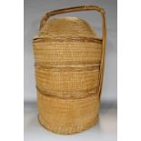 A Chinese three tier wedding basket with a bamboo handle 56cm high.