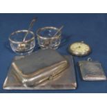 A silver cigarette case, a vesta, a smaller cigarette case, pocket watch, two glass salts with