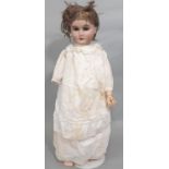 Early 20th century German bisque head doll by Gebruder Kuhnlenz, mould 165, 55cm tall, with brown