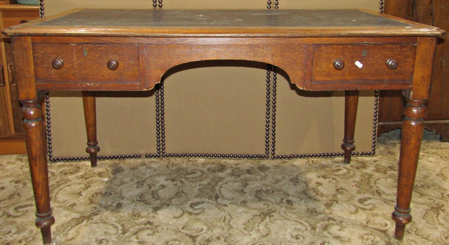 A Victorian oak kneehole desk, the rectangular top with moulded outline canted corners and faux