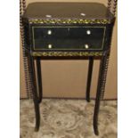 A Georgian style ebonised sewing/workbox with decorative gilt painted scrolling foliate and line