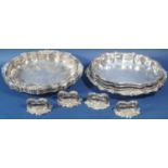 A set of four silver plated tureens with covers and removable handles, decorated with vine leaves