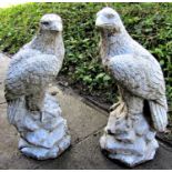 A pair of cast composition stone pier caps in the form of eagles perched on rocky outcrops 58 cm