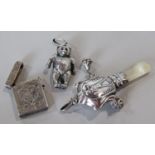 A small child's silver rattle in the form of a teddy bear, further silver plated example with mother