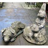 Three weathered cast composition stone garden ornaments in the form of a family of rabbits, a