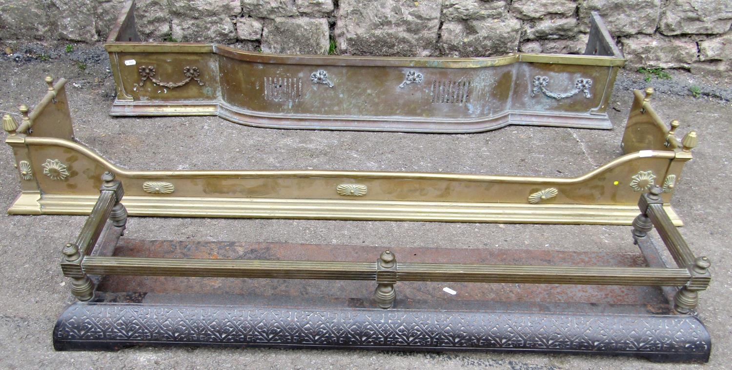 Two Edwardian brass fenders of varying size and design, both with applied neo classical detail,