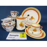 A collection of art deco teawares with orange, yellow and black painted geometric decoration and