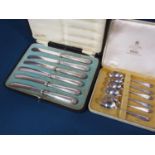 A cased set of silver handled butter knives and a cased set of five matching teaspoons and one other