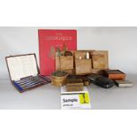 A miscellaneous collection of items including, treen boxes, a slide rule, a boxed set of knives, a