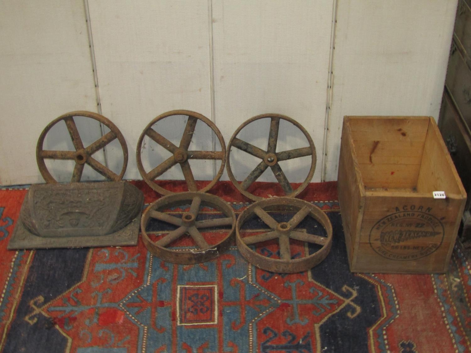 A vintage agricultural plough attachment together with five small iron five spoke wheels, 30 cm in