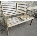 A contemporary weathered hardwood two seat garden bench with slatted seat and back, 120 cm long