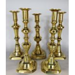 Five similar brass candlesticks.