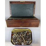 A distressed 19th century writing box and a box of 100's of keys.