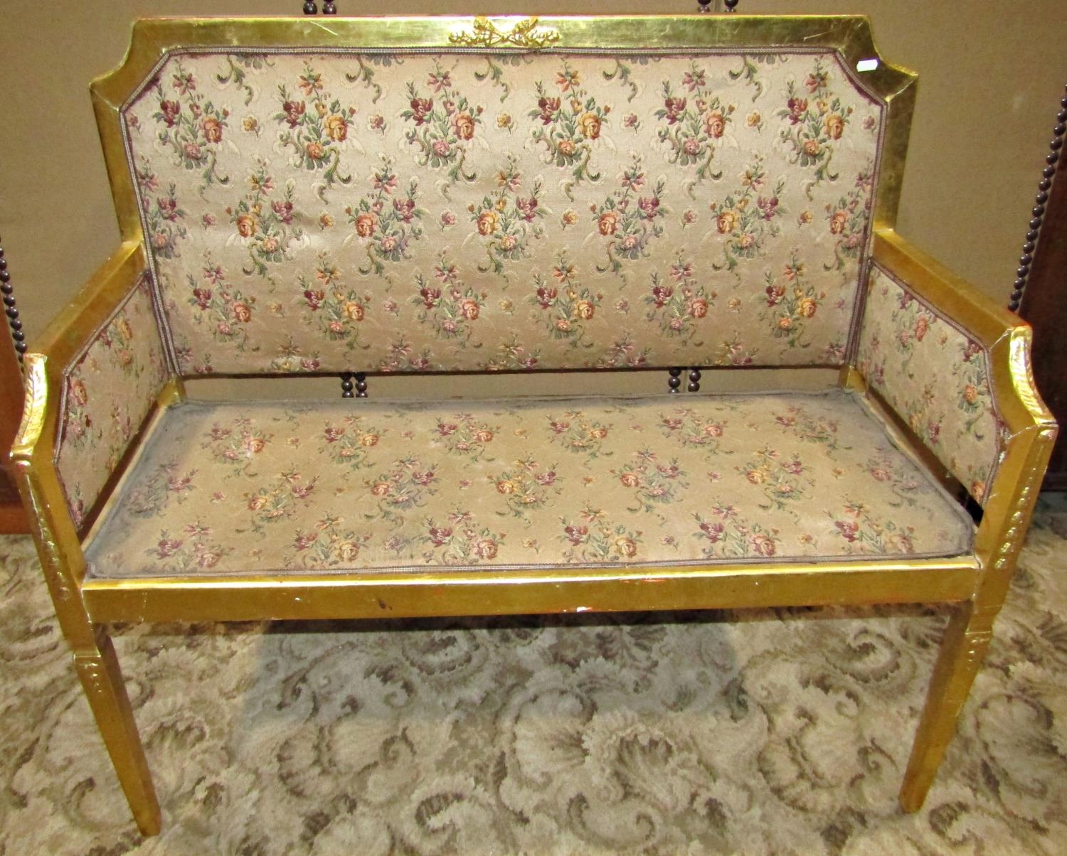 Two seat light weight parlour or salon sofa, with upholstered pad seat back and arms within a gilt