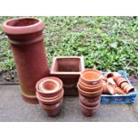 A terracotta chimney pot of cylindrical and slightly tapered form together with approximately 60