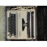 A cased Olympia reporter electric typewriter together with boxed AOC Led flatscreen monitor and a HP