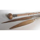 Two antique African Masai spears with facetted carved body and iron spiked end decorated midway with