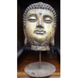 Heavy cast iron buddha head with later gilded finish raised on a simple stand 50 cm max