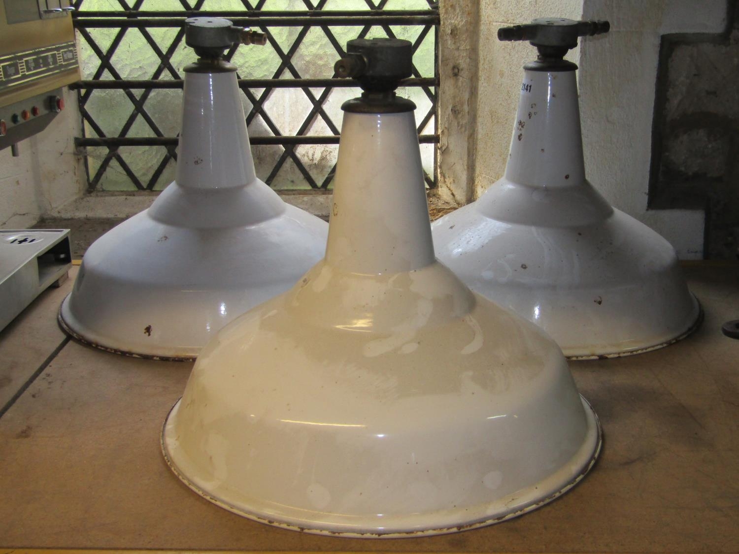 A set of three vintage industrial enamel hanging ceiling/pendant lights with dome shades, one with