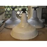 A set of three vintage industrial enamel hanging ceiling/pendant lights with dome shades, one with