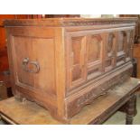 An 18th century oak coffer with hinged lid and panelled frame, the front elevation with geometric