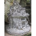 A weathered novelty cast composition stone garden ornament in the form of a woodland fairyland