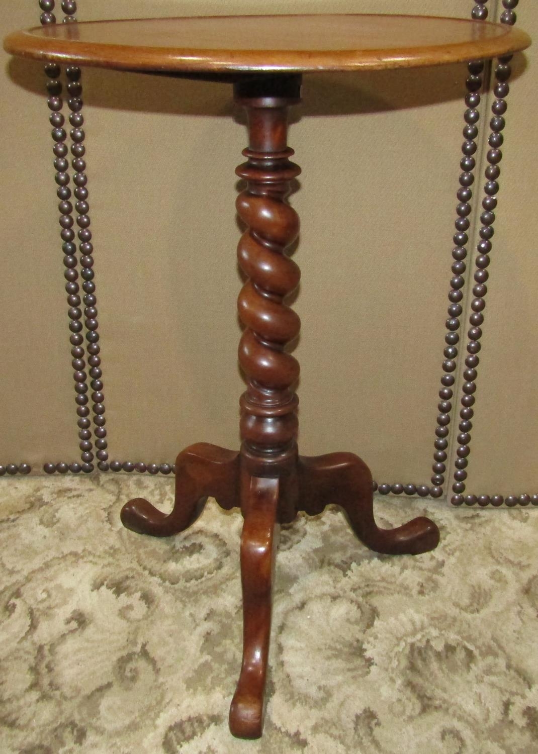 A Victorian mahogany occasional table, the circular tray top raised on a spiral twist pillar on