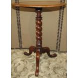 A Victorian mahogany occasional table, the circular tray top raised on a spiral twist pillar on