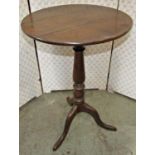 A 19th century oak occasional table of circular form raised on a turned pillar and swept tripod,