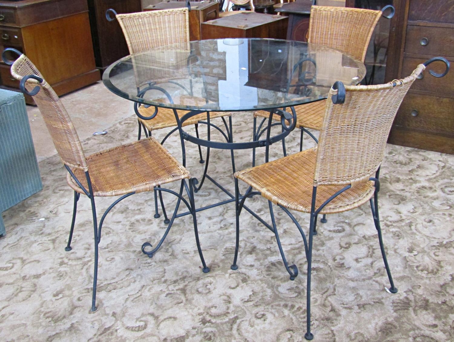 A contemporary iron framed five piece conservatory or patio suite comprising a circular table with