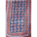 An antique Kazak design runner with a central panel of stylised flowers, 240cm x 90cm