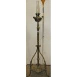 A Victorian brass telescopic oil lamp standard with pierced and scrolling detail on lions paw feet