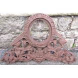 A small cast iron plaque with oval vacant frame, scrolling acanthus detail and latin script, 55 cm x