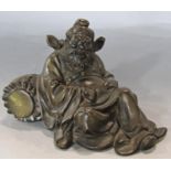 A Chinese bronze of a drunken sage reclined on a wine barrel. 12cm wide.
