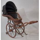 2 Victorian style dolls push chairs, both of wicker and metal work, with the smaller having a