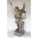 A terracotta figure of a night watchmen holding aloft his lamp 80 cm high approximately (in the