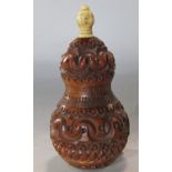 A coquilla nut thread holder profusely carved with a screw top and bone finial 9cm tall.