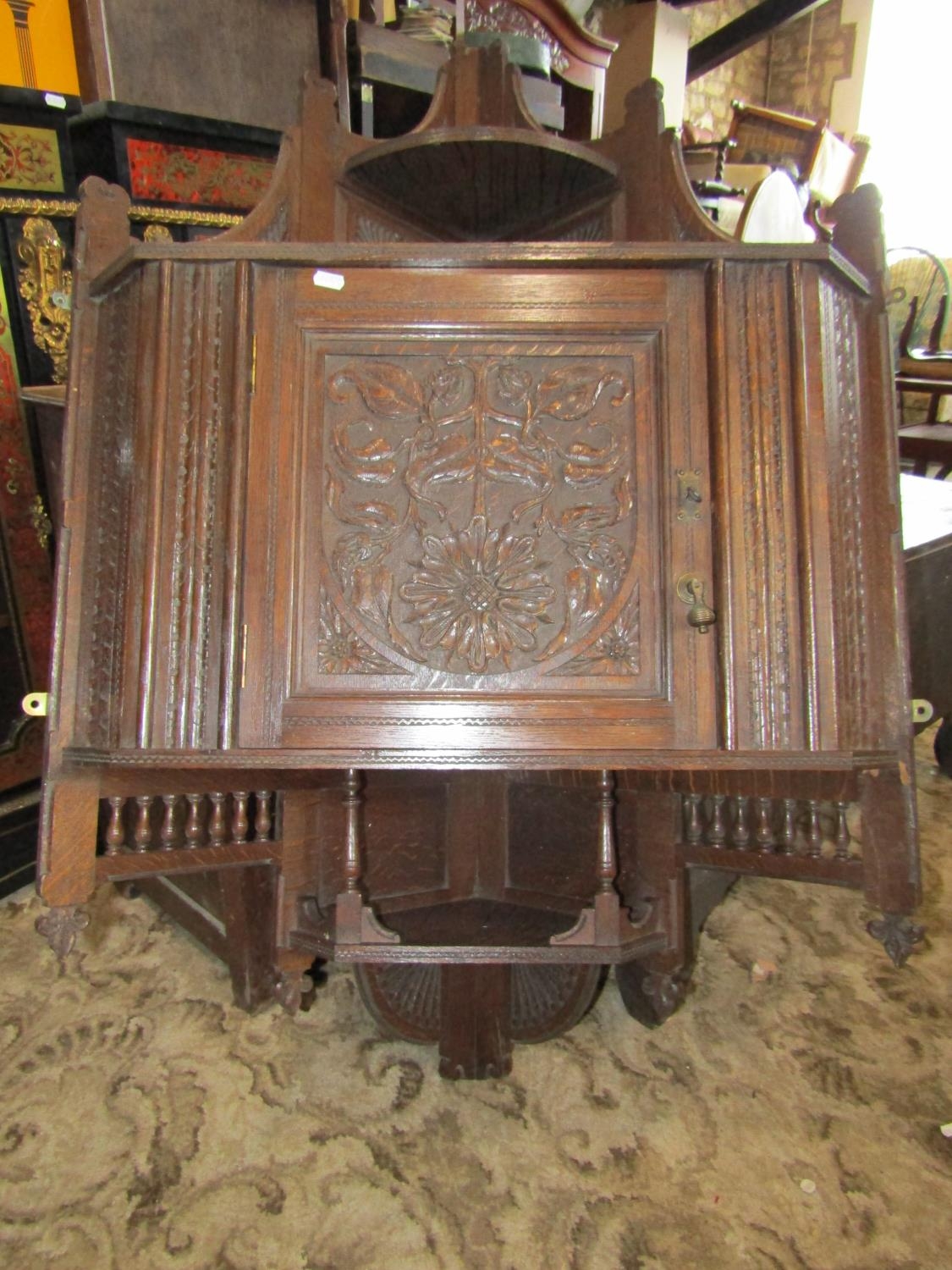 A late Victorian oak hanging corner cupboard, enclosed by a square panelled door with carved foliate - Image 2 of 5